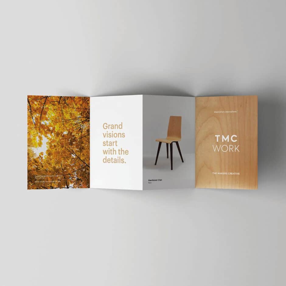 An open brochure with four panels: autumn leaves, "Grand visions start with the details" text, a wooden chair, and "TMC Work" on a light wood texture.