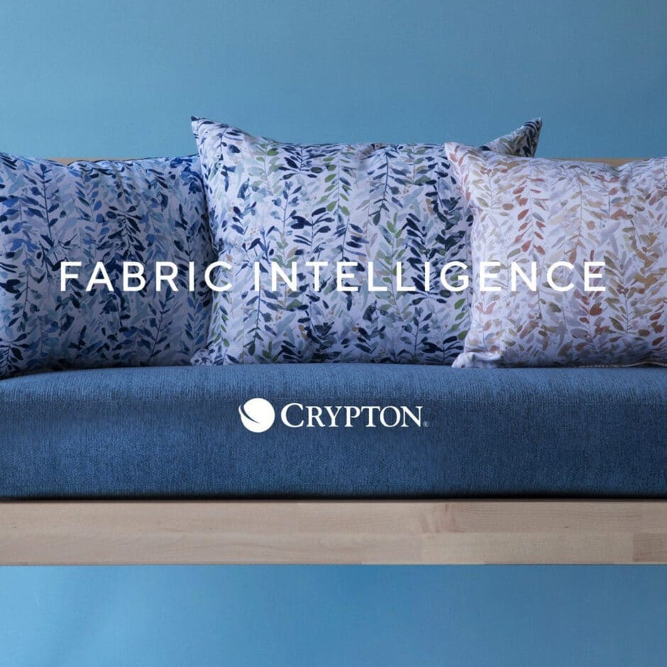 Three decorative pillows with blue and white leaf patterns sit on a blue cushioned wooden bench. Text reads "Fabric Intelligence," with the Crypton logo below.