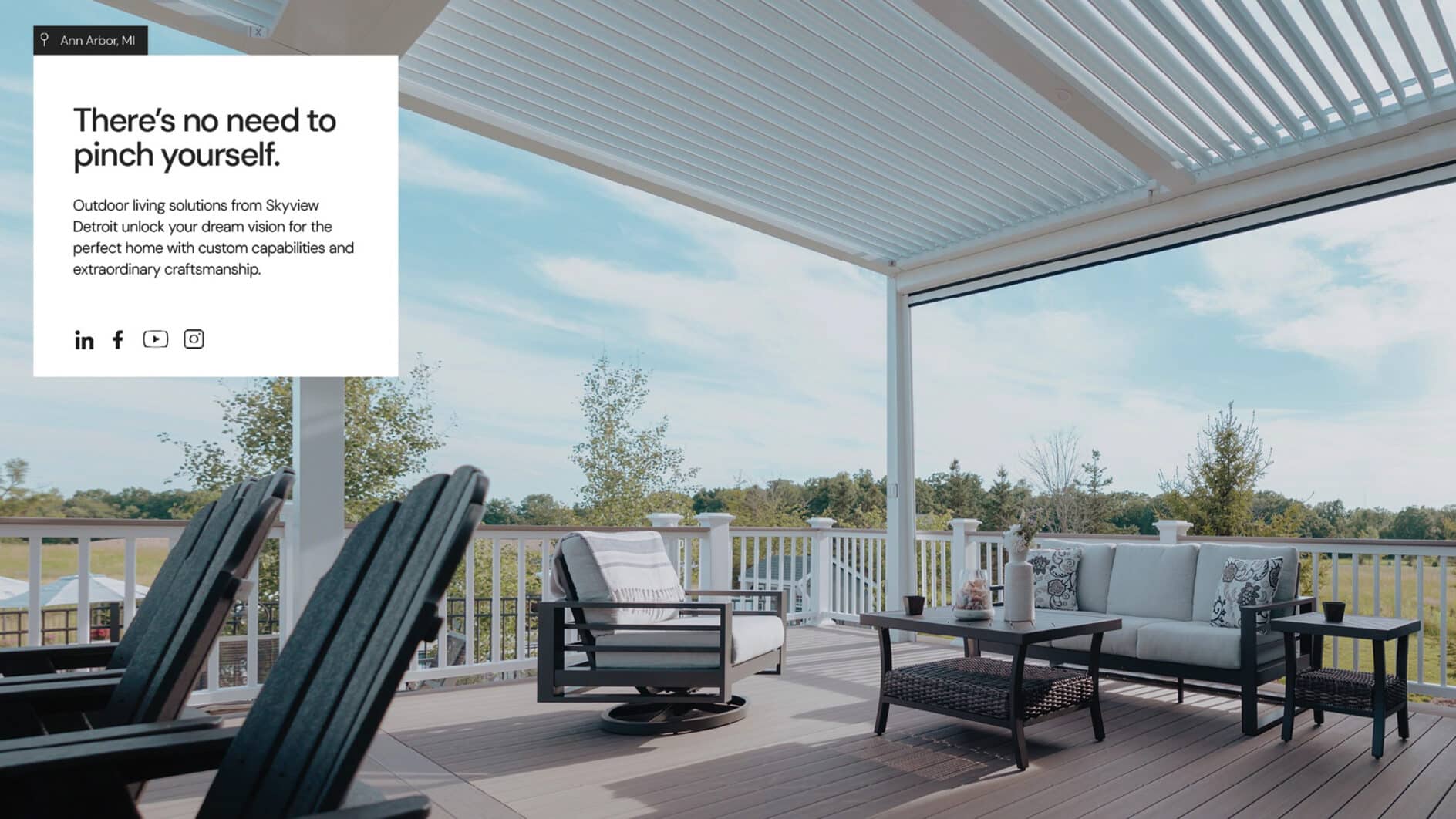 Outdoor patio with modern furniture under a white pergola, overlooking a scenic landscape. Text on the left promotes outdoor living solutions. Tone is serene.