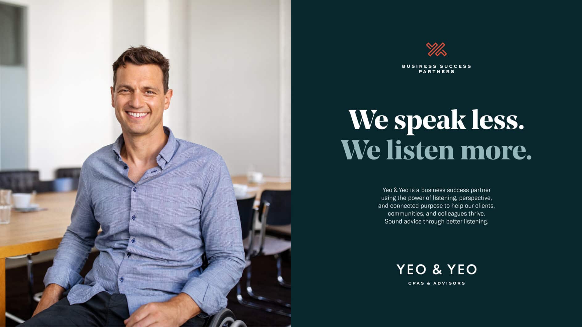 A person smiling in a conference room is seated at a table. Adjacent text on a dark background reads: "We speak less. We listen more.” A calm, professional tone.